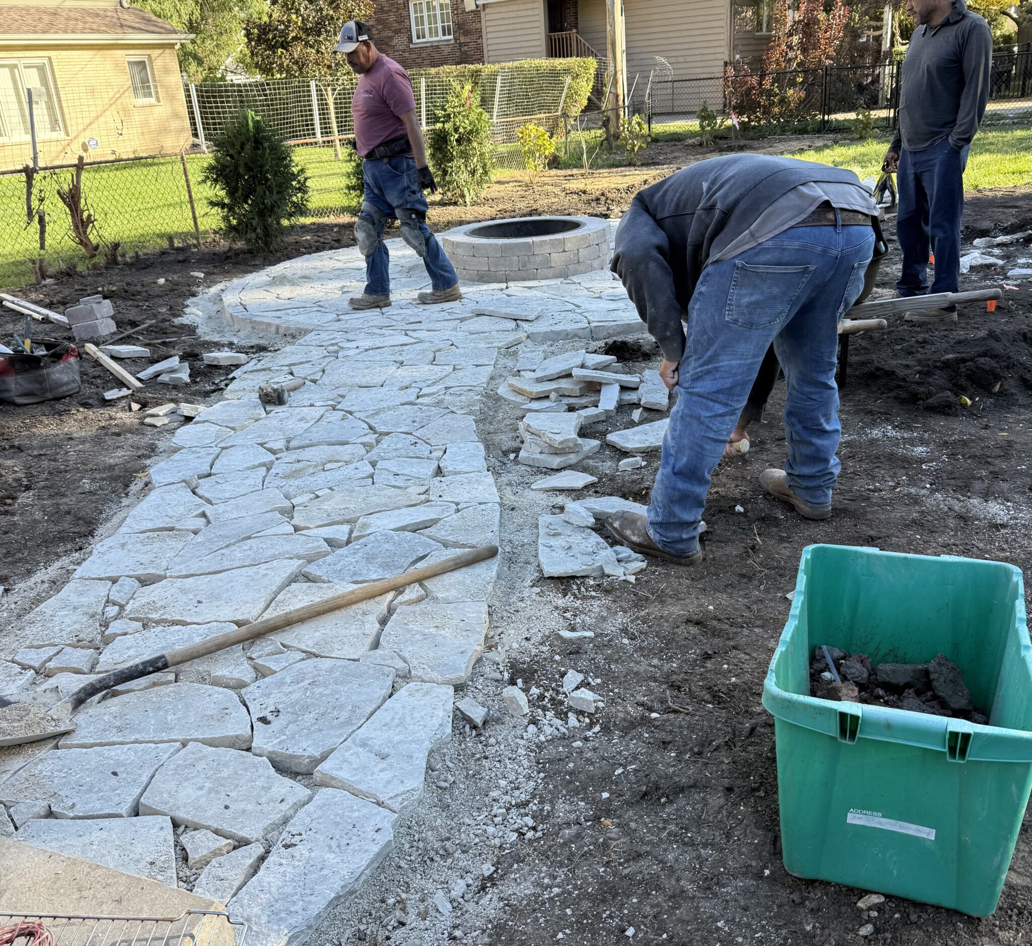 Crew laying an irregular flagstone walkway